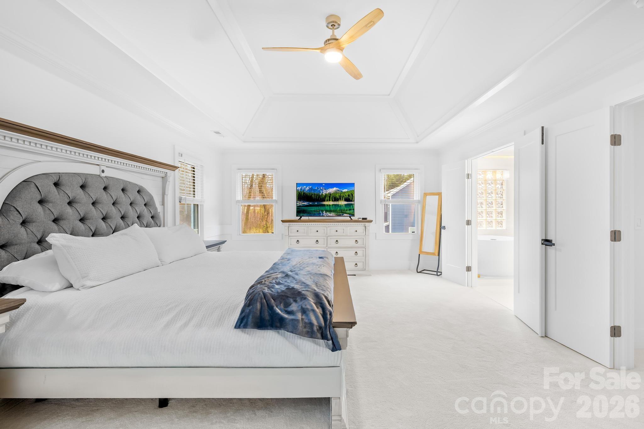 18441 Davidson-Concord Road Davidson, NC 28036 - Photo 24 of 36 a bedroom with a large bed and ceiling fan