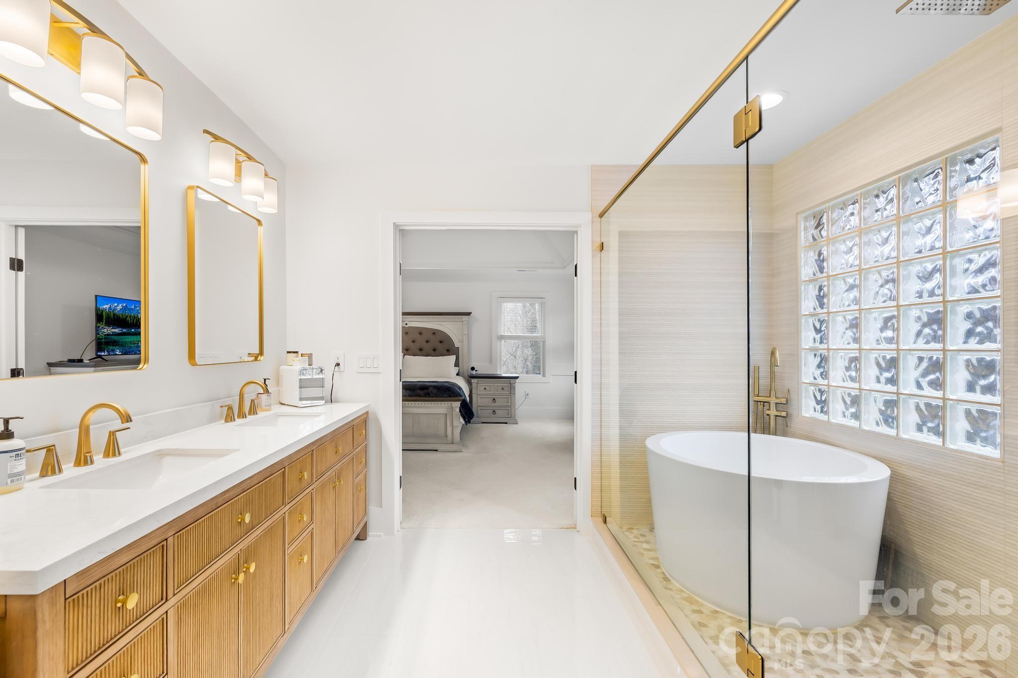 18441 Davidson-Concord Road Davidson, NC 28036 - Photo 26 of 36 a bathroom with a tub sink and mirror