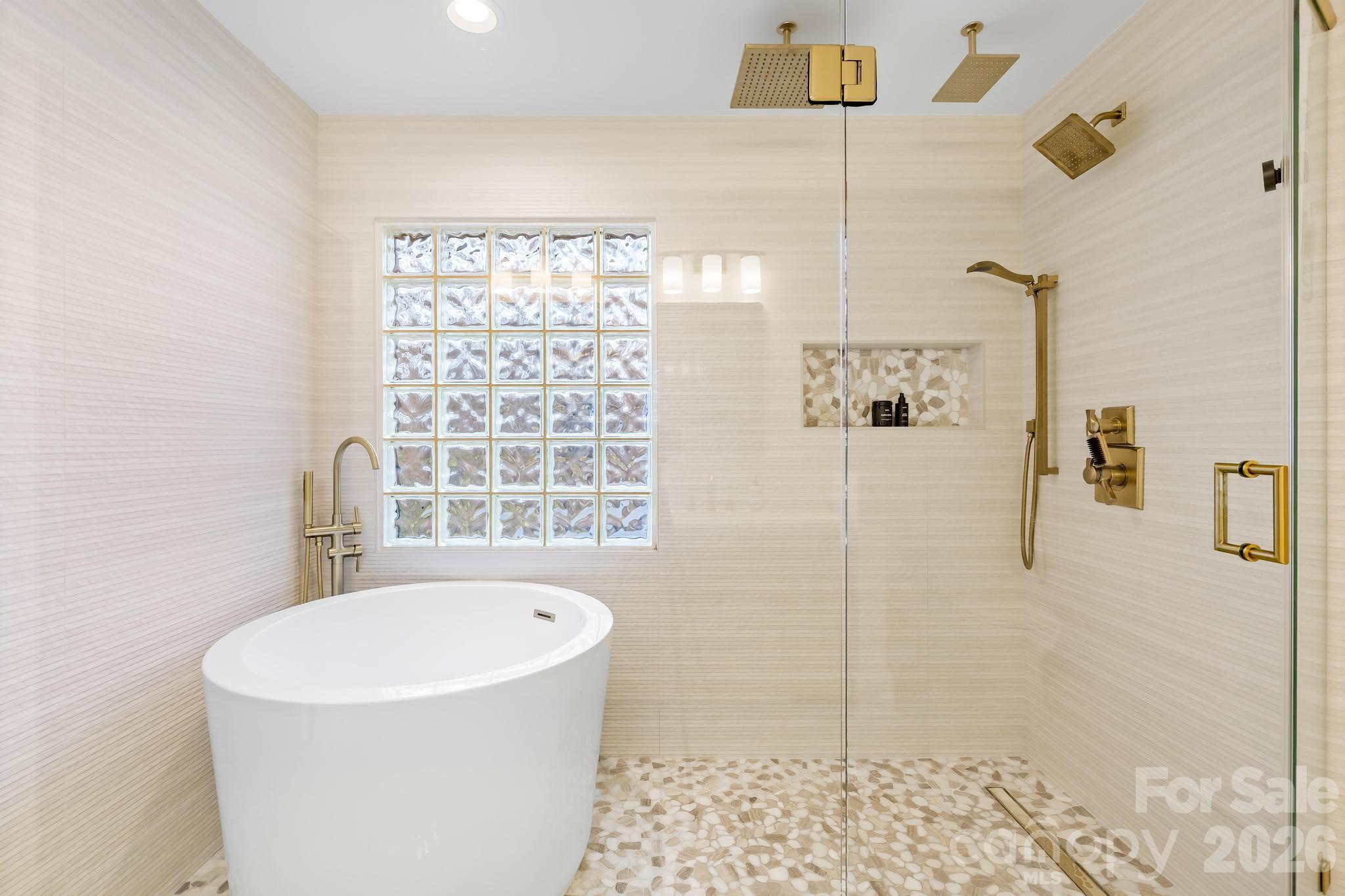 18441 Davidson-Concord Road Davidson, NC 28036 - Photo 27 of 36 a bathroom with a bathtub and a shower