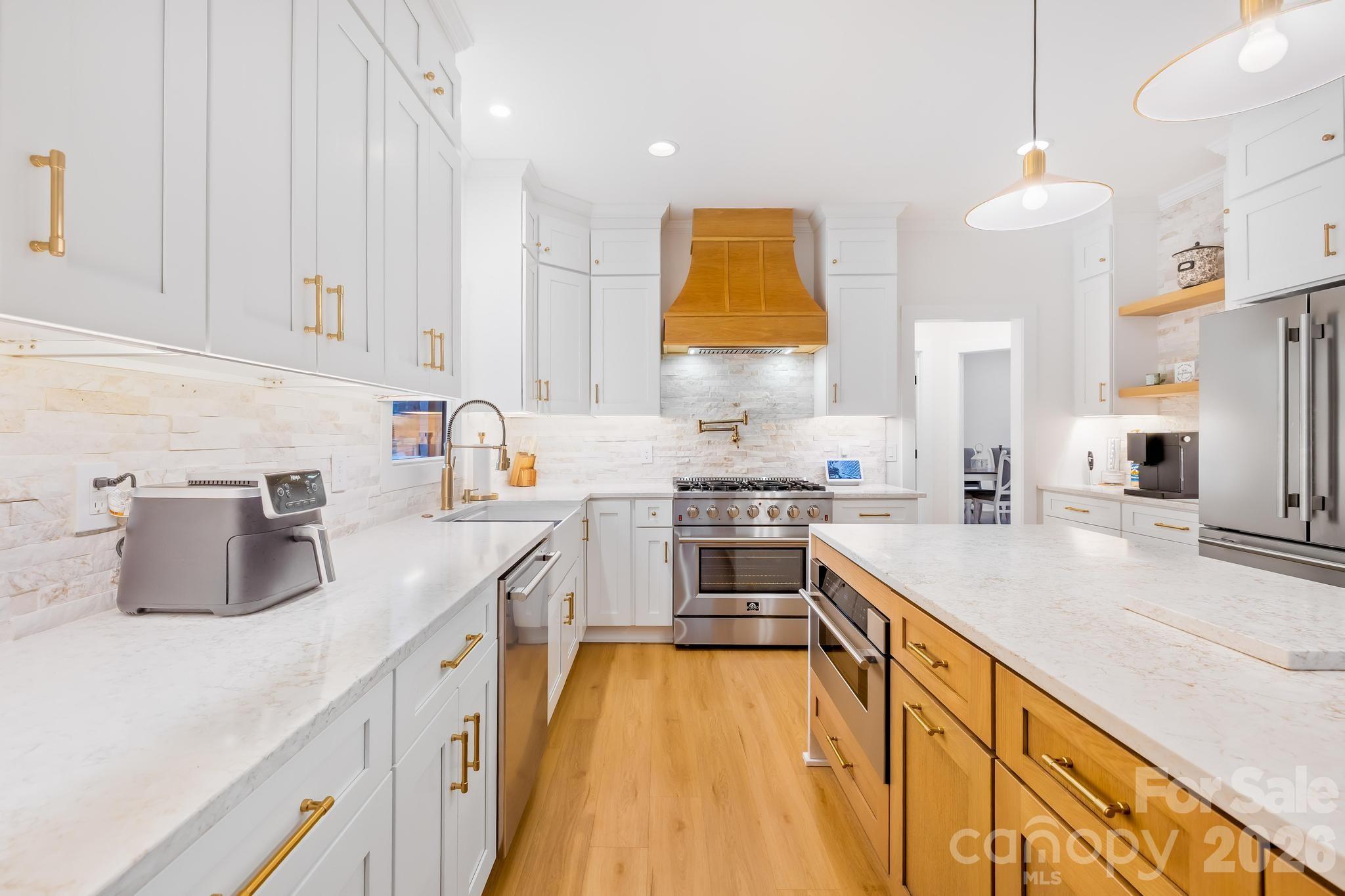 18441 Davidson-Concord Road Davidson, NC 28036 - Photo 9 of 36 a kitchen with a sink stove and refrigerator