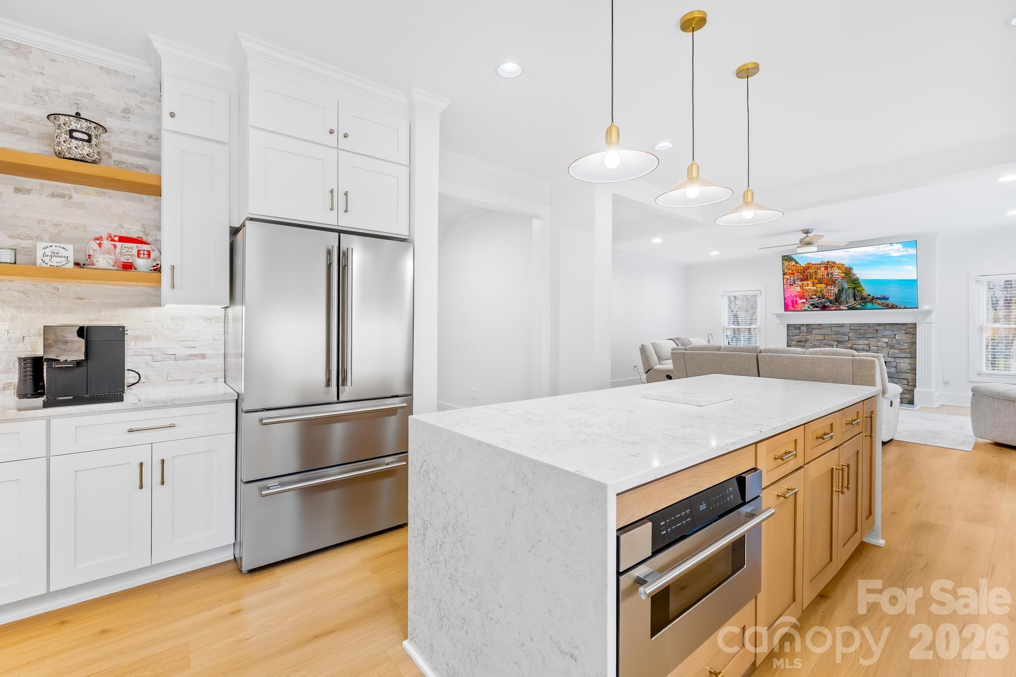 18441 Davidson-Concord Road Davidson, NC 28036 - Photo 10 of 36 a kitchen with kitchen island a sink appliances and cabinets