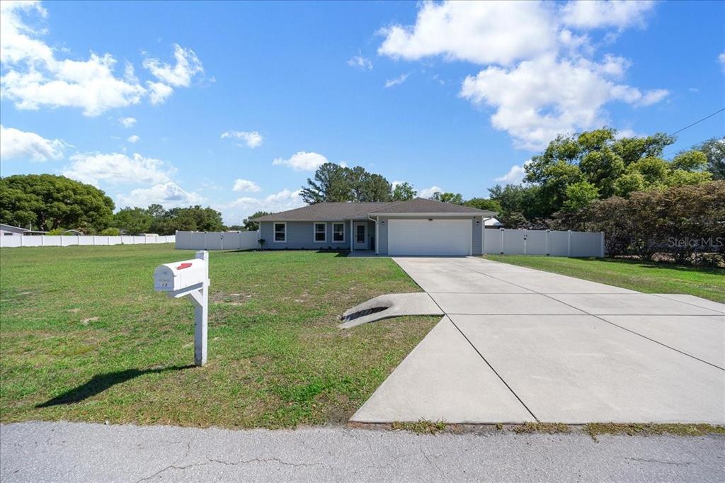 13 Teak Loop Place Ocala, FL 34472 - Photo 3 of 36 a view of a house with a yard and a garden