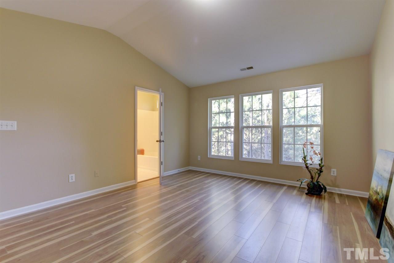 5056 Babbling Brook Drive Raleigh, NC 27610 - Photo 13 of 28 vaulted ceiling and triple windows looking private backyard