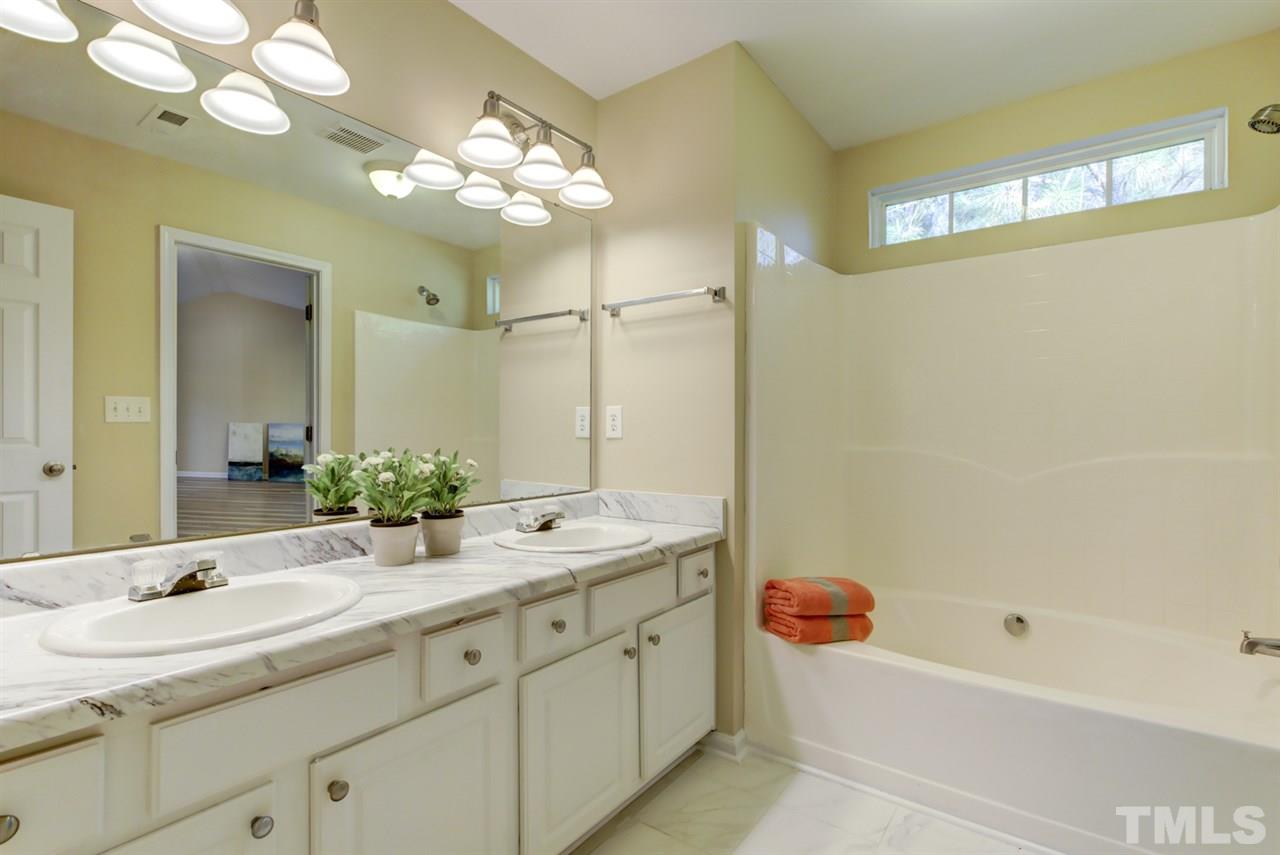 5056 Babbling Brook Drive Raleigh, NC 27610 - Photo 15 of 28 Tile floor and garden tub. Separate toilet room