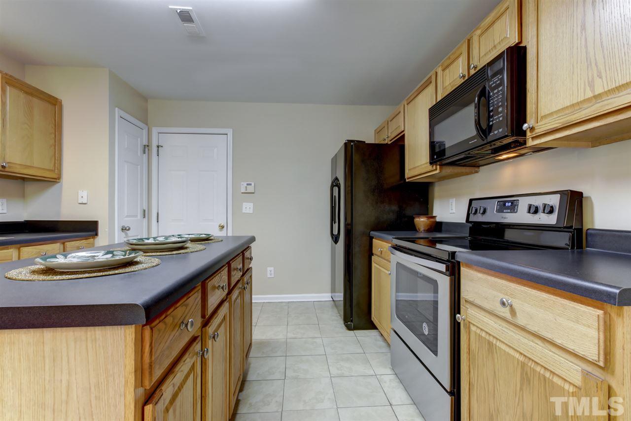 5056 Babbling Brook Drive Raleigh, NC 27610 - Photo 9 of 28 open kitchen with upgraded appliances. Big island for cooking and convenience