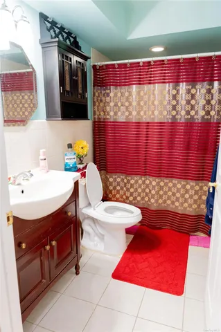 a bathroom with a sink a toilet and a shower