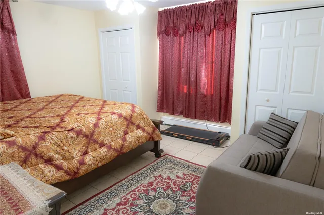 a bedroom with a bed and a couch