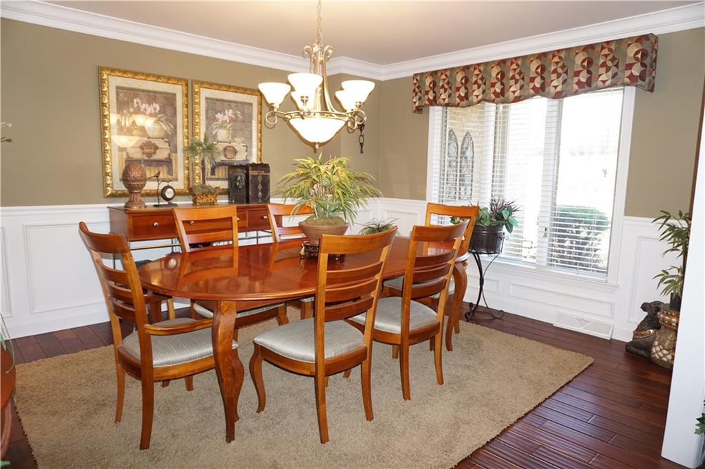 1011 Timber Ridge Court Harrison City, PA 15636 - Photo 3 of 25 Formal dinning room is located off the entry that is also updated with the new wood flooring. Custom moldings including crown, chair rail and shadow boxing enhance the richness of this formal space.