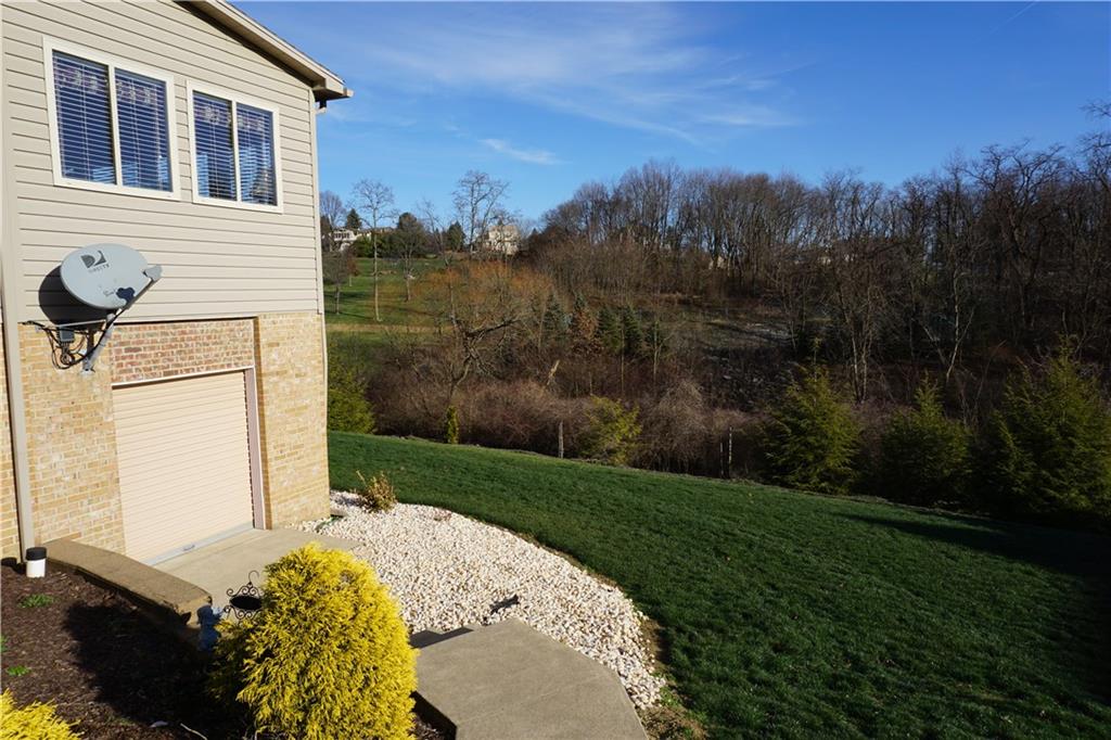 1011 Timber Ridge Court Harrison City, PA 15636 - Photo 22 of 25 Sidewalk from the driveway lead to the storage garage that is under the finished sunroom!
