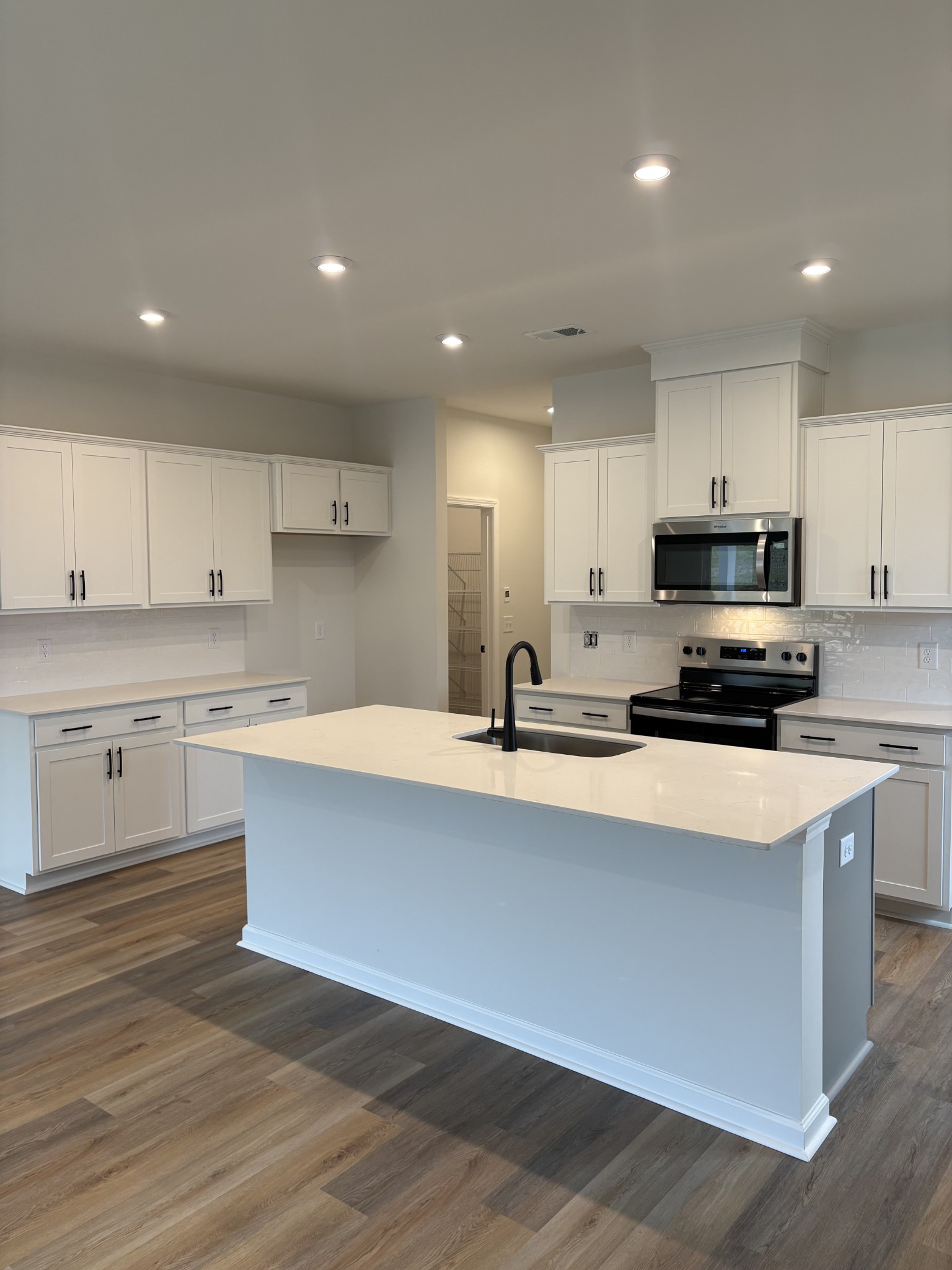 2136 Cheltenham Place Columbia, TN 38401 - Photo 10 of 31 a kitchen with stainless steel appliances granite countertop a sink a stove a refrigerator a microwave and cabinets