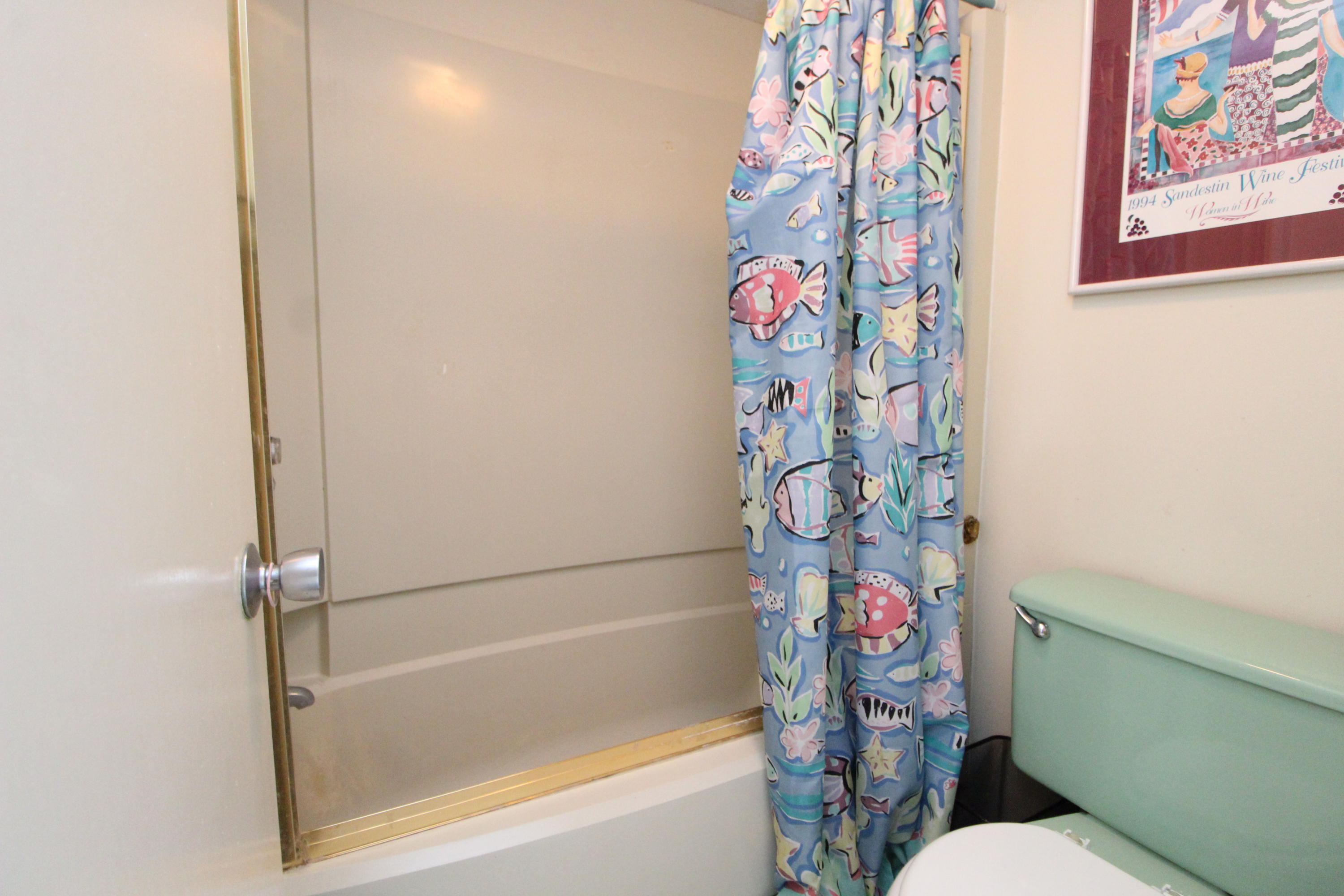 909 Santa Rosa Boulevard, Unit 548 Fort Walton Beach, FL 32548 - Photo 11 of 22 a bathroom with a bathtub and a shower curtain
