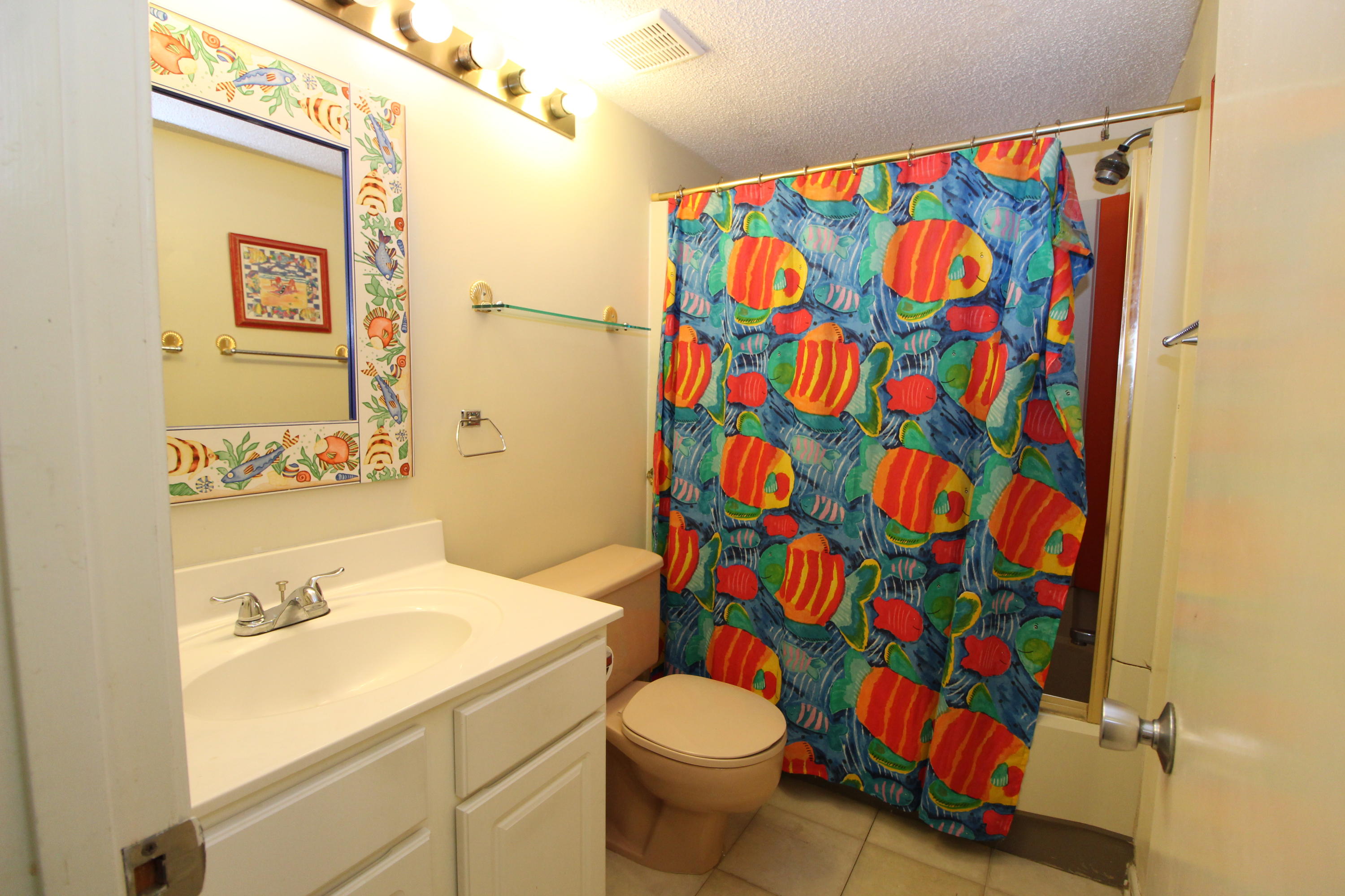 909 Santa Rosa Boulevard, Unit 548 Fort Walton Beach, FL 32548 - Photo 14 of 22 a bathroom with a sink toilet and shower