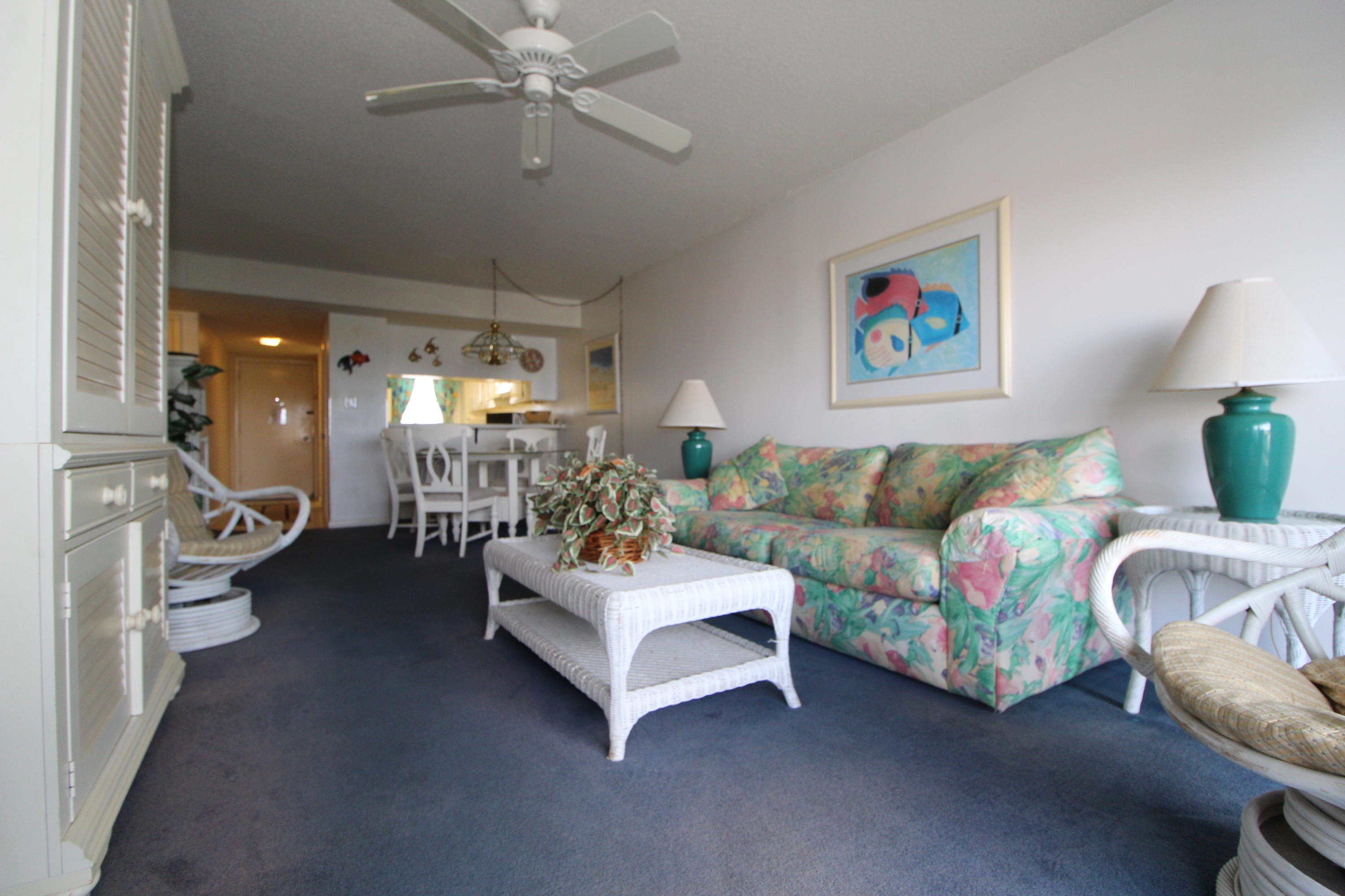 909 Santa Rosa Boulevard, Unit 548 Fort Walton Beach, FL 32548 - Photo 3 of 22 a living room with furniture and a chandelier