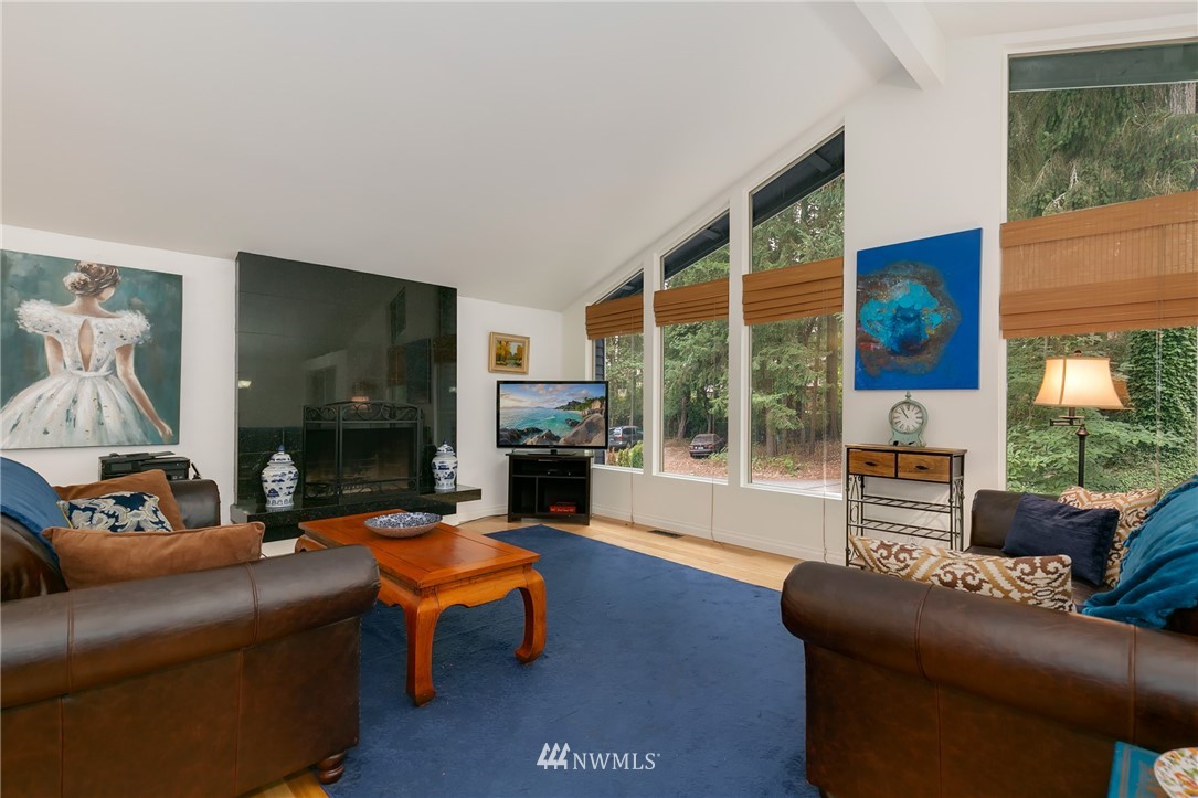 24303 23rd Avenue West Bothell, WA 98021 - Photo 8 of 25 a living room with furniture a large window and a flat screen tv