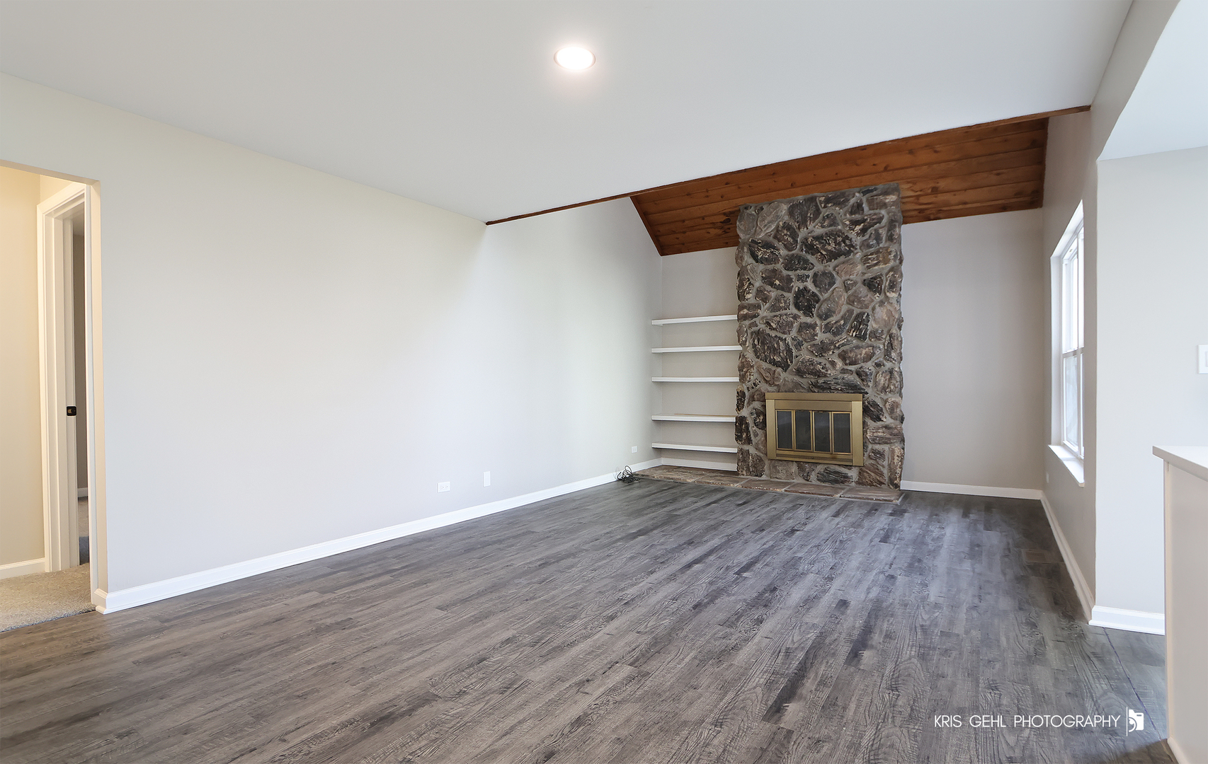 695 Wakefield Road Gurnee, IL 60031 - Photo 3 of 24 an empty room with wooden floor and fireplace