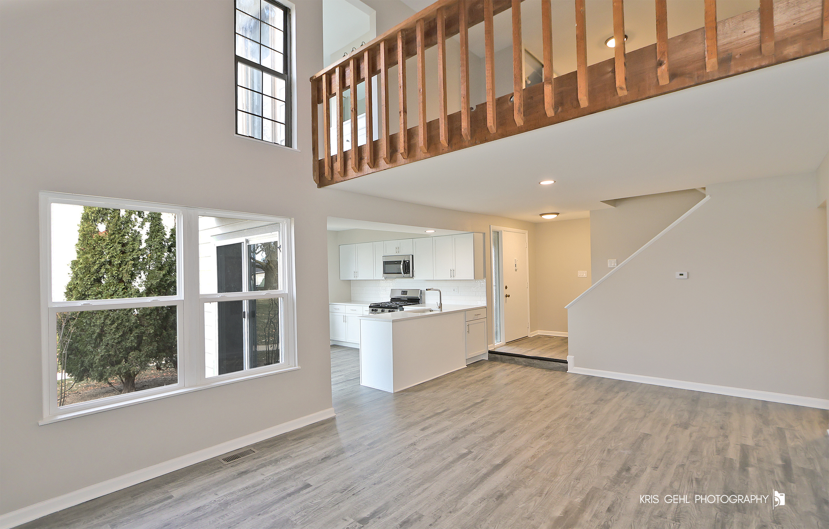 695 Wakefield Road Gurnee, IL 60031 - Photo 4 of 24 a hallway with windows and chandelier