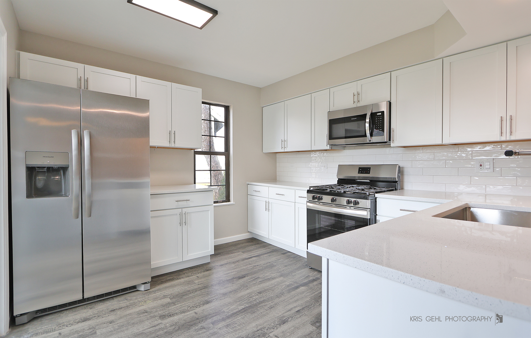 695 Wakefield Road Gurnee, IL 60031 - Photo 6 of 24 a kitchen with white cabinets and stainless steel appliances