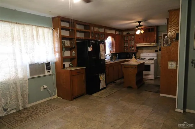 a kitchen with refrigerator and window