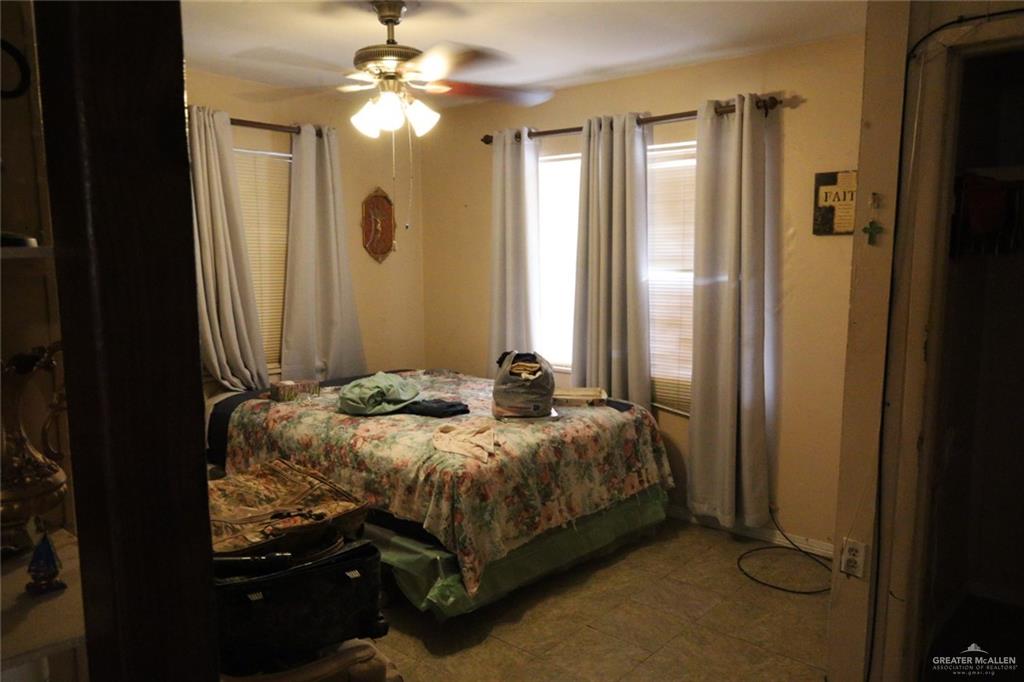 7716 North Val Verde Road Donna, TX 78537 - Photo 15 of 17 a bedroom with a bed and a chandelier