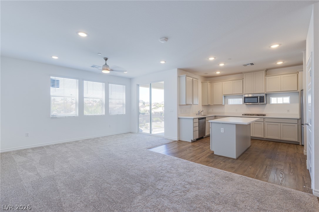 2555 Hampton Road, Unit 8206 Henderson, NV 89052 - Photo 6 of 25 An open-concept living area seamlessly transitions to a well-appointed kitchen, ideal for modern living.