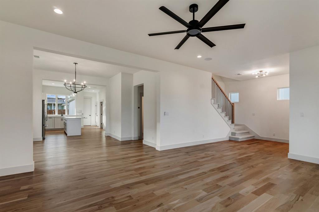 205 West 7th Street Justin, TX 76247 - Photo 11 of 35 a view of an empty room with wooden floor and a ceiling fan