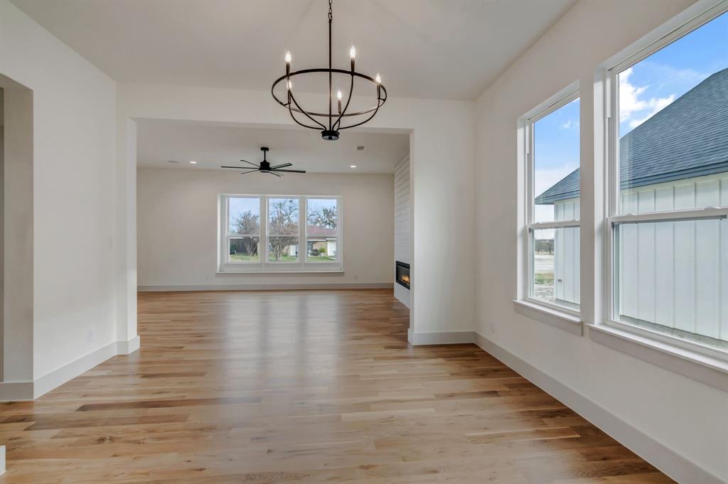 205 West 7th Street Justin, TX 76247 - Photo 16 of 35 a view of an empty room with wooden floor and fan