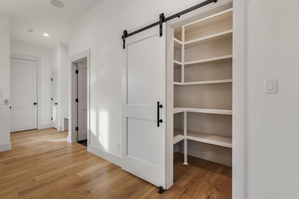 205 West 7th Street Justin, TX 76247 - Photo 19 of 35 a view of walk in closet with empty racks