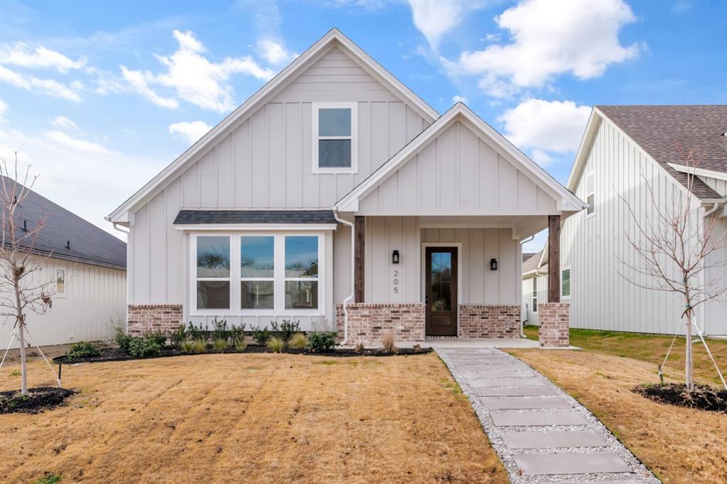 205 West 7th Street Justin, TX 76247 - Photo 2 of 35 a front view of a house with yard