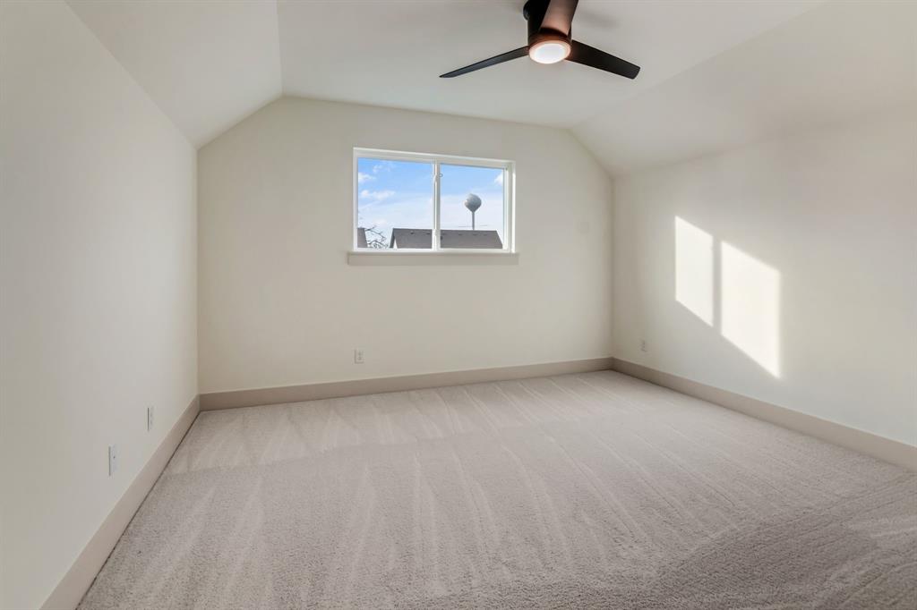 205 West 7th Street Justin, TX 76247 - Photo 23 of 35 an empty room with a window and a ceiling fan