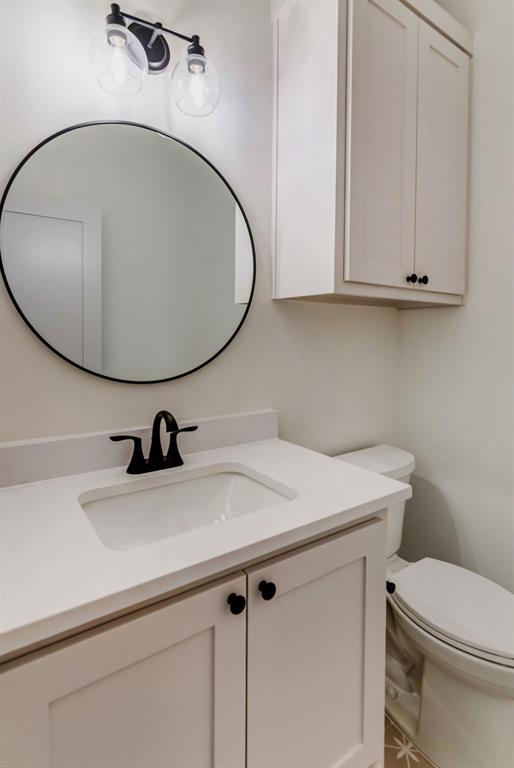 205 West 7th Street Justin, TX 76247 - Photo 26 of 35 a bathroom with a sink and a mirror