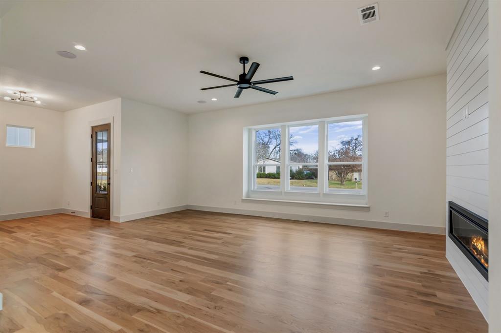 205 West 7th Street Justin, TX 76247 - Photo 5 of 35 wooden floor in an empty room with a window