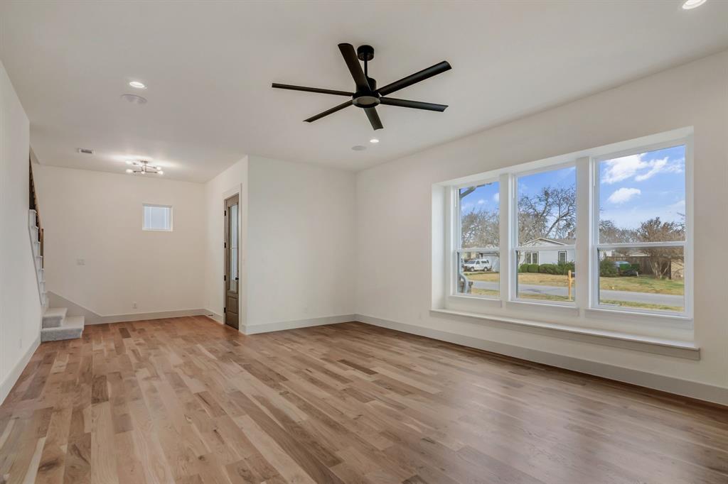 205 West 7th Street Justin, TX 76247 - Photo 10 of 35 a view of a livingroom with a ceiling fan & window