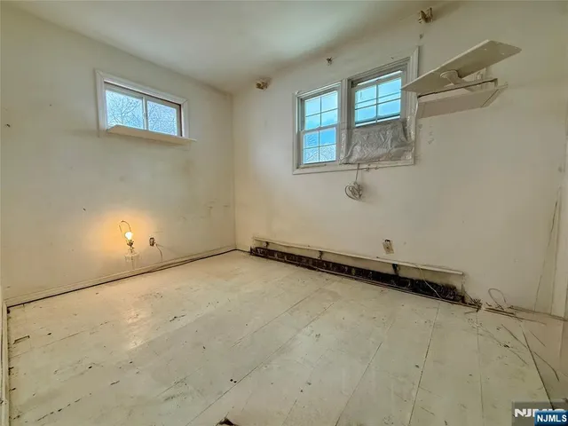 a front view of a house with a yard covered in snow