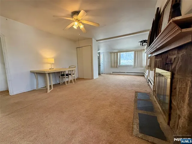a view of a livingroom with furniture and a ceiling fan