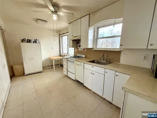 a large white kitchen with a window