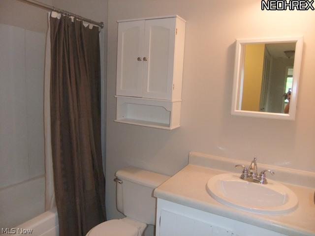 992 Hampton Ridge Drive Akron, OH 44313 - Photo 11 of 17 Step upstairs to the 3 bedrooms and full bathroom. The bathroom features a white vanity and tub surround.