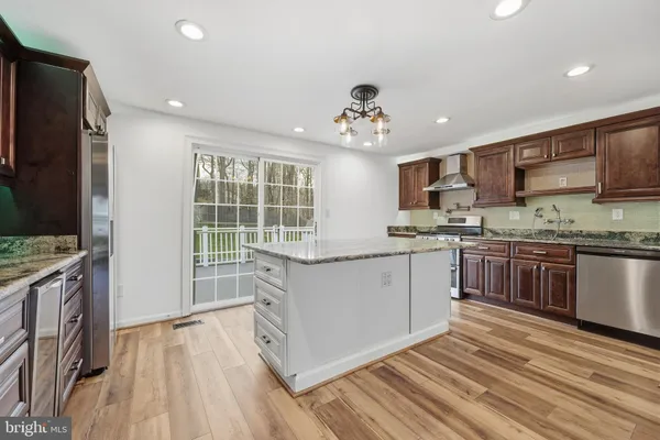 a kitchen with a refrigerator and a sink