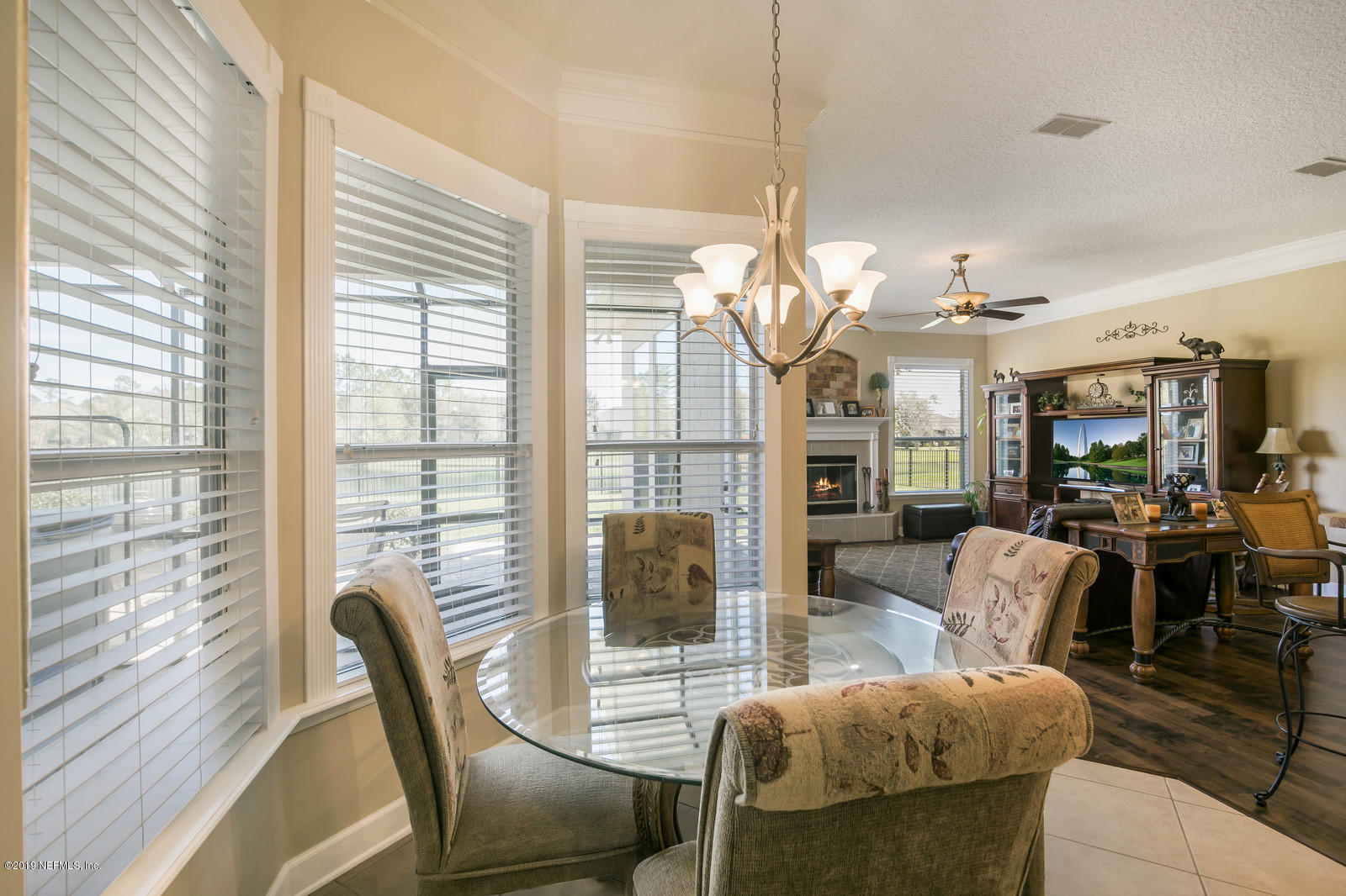 2034 River's Own Road St. Augustine, FL 32092 - Photo 13 of 40 a view of a dining room with furniture large windows and wooden floor