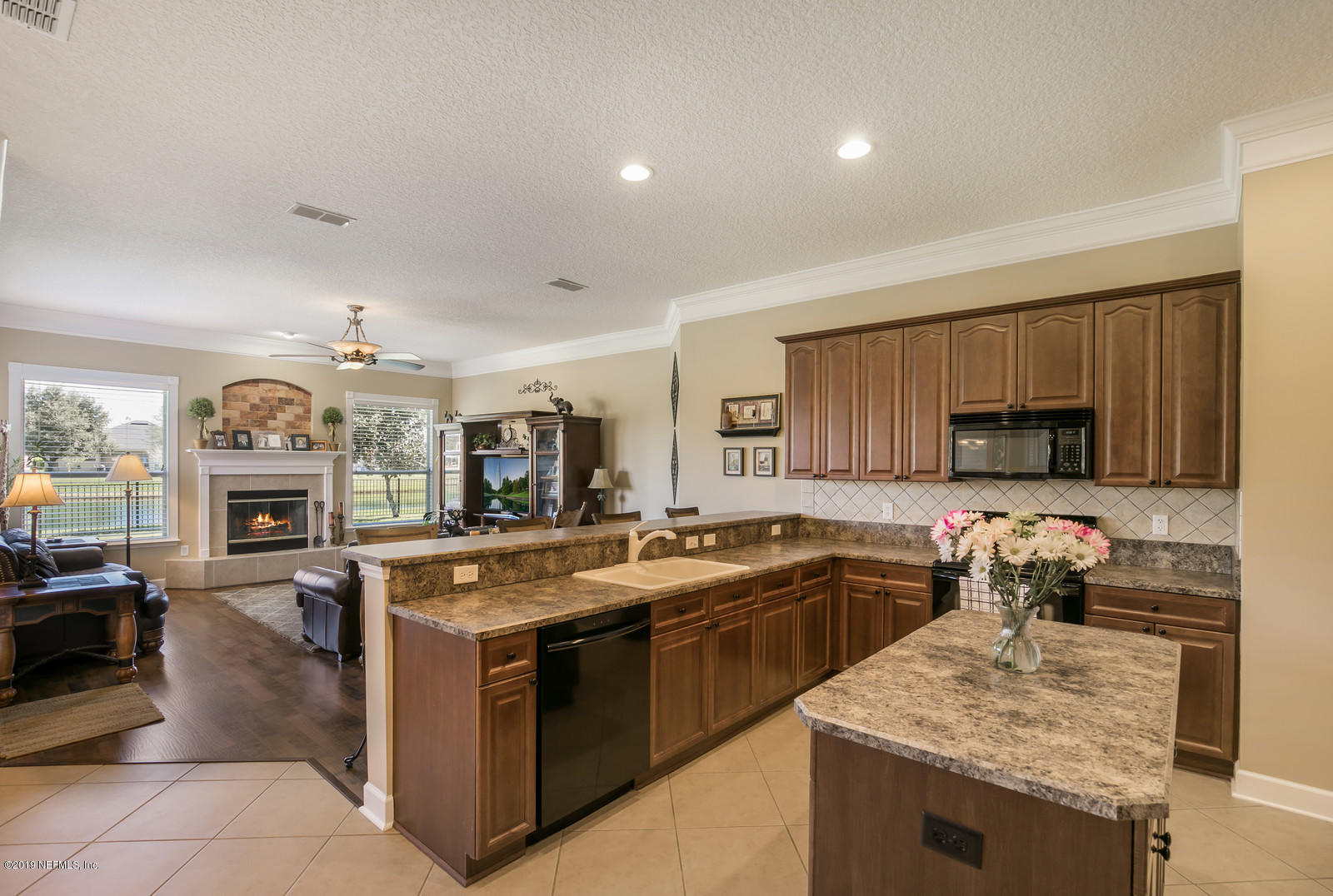 2034 River's Own Road St. Augustine, FL 32092 - Photo 15 of 40 a kitchen with granite countertop a stove top oven sink and cabinets