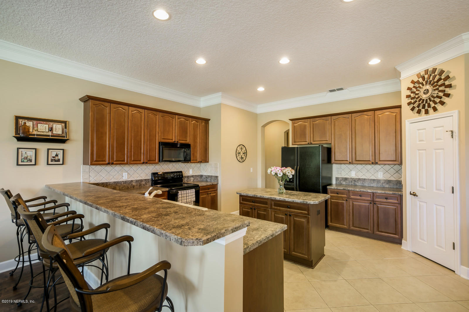2034 River's Own Road St. Augustine, FL 32092 - Photo 16 of 40 a kitchen with stainless steel appliances a stove sink microwave and refrigerator