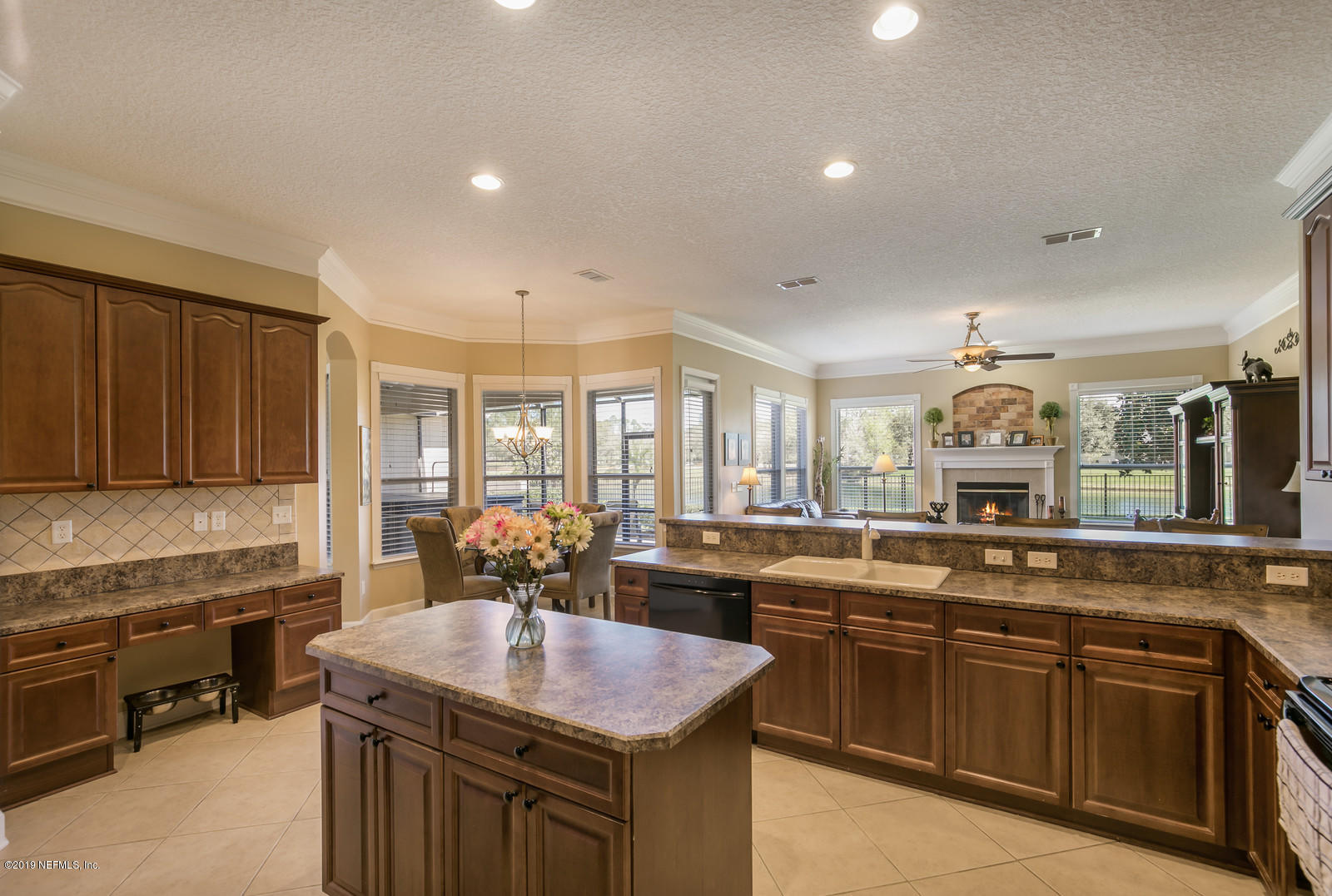 2034 River's Own Road St. Augustine, FL 32092 - Photo 18 of 40 a kitchen with kitchen island granite countertop a sink stove and cabinets