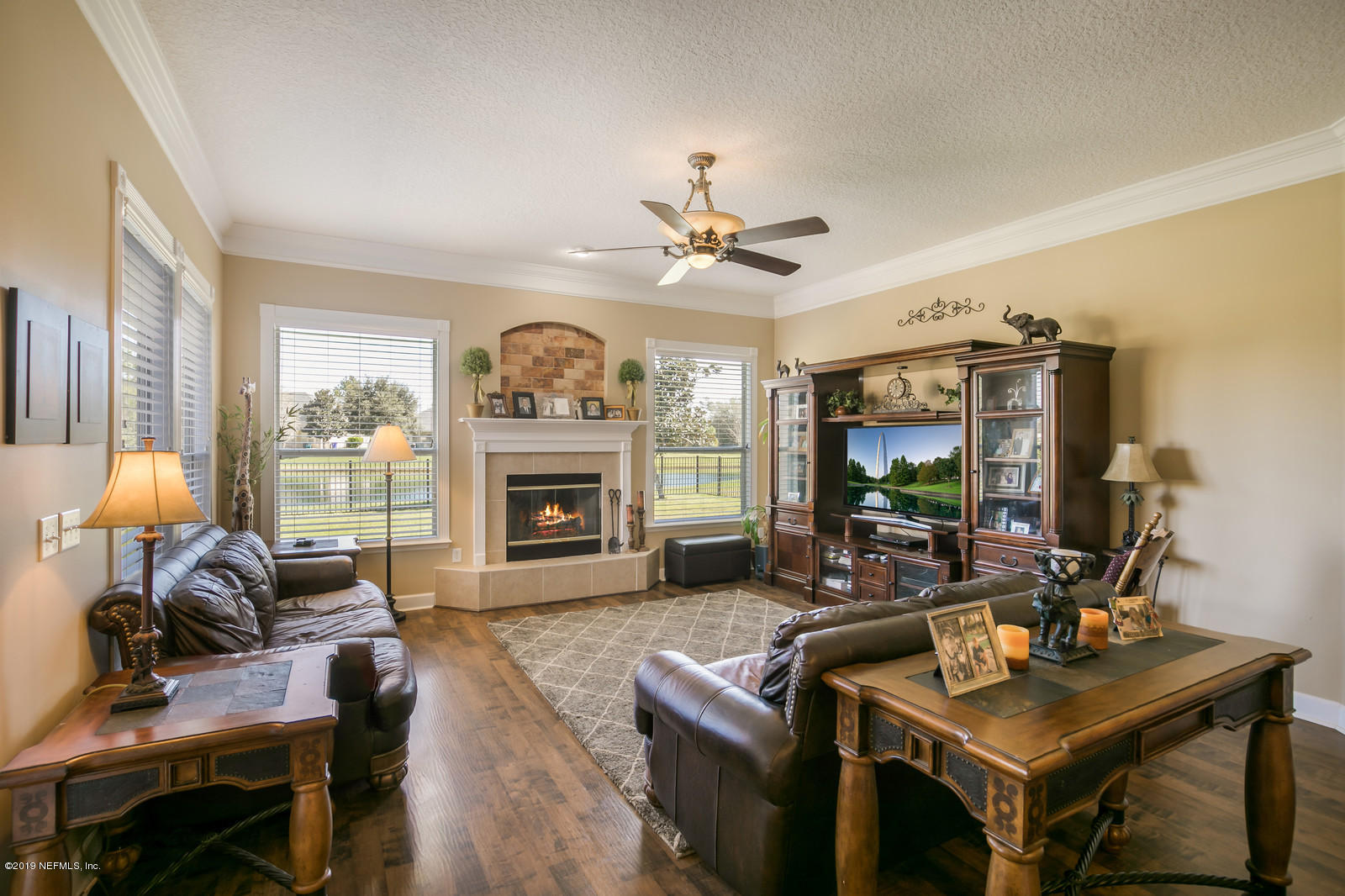2034 River's Own Road St. Augustine, FL 32092 - Photo 20 of 40 a living room with furniture a fireplace and a flat screen tv