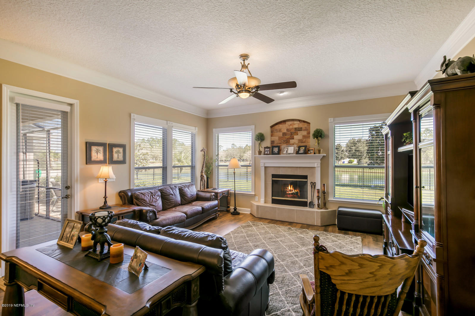 2034 River's Own Road St. Augustine, FL 32092 - Photo 21 of 40 a living room with furniture a large window and a fireplace