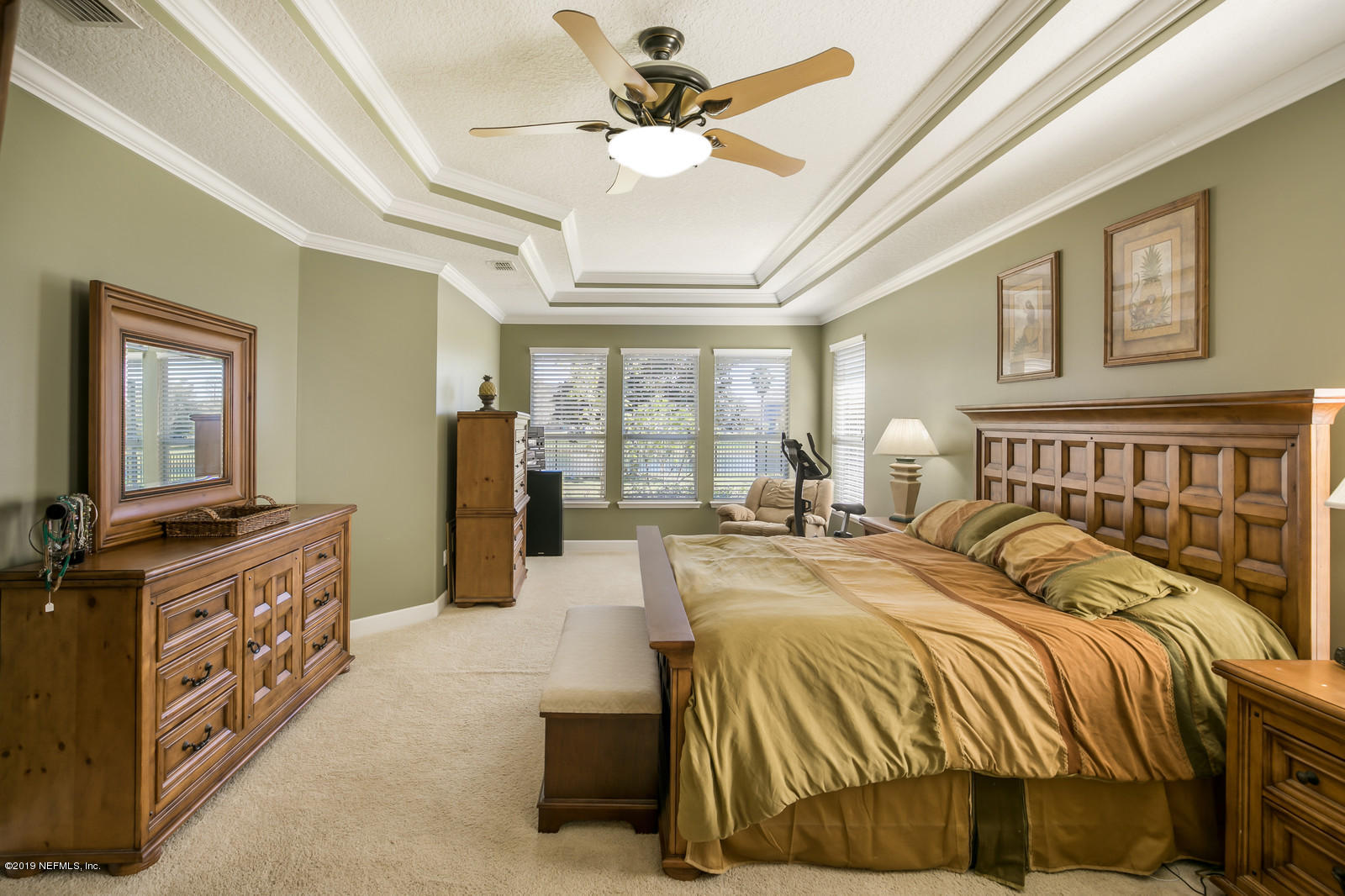 2034 River's Own Road St. Augustine, FL 32092 - Photo 24 of 40 a spacious bedroom with a bed and glass walk in closet