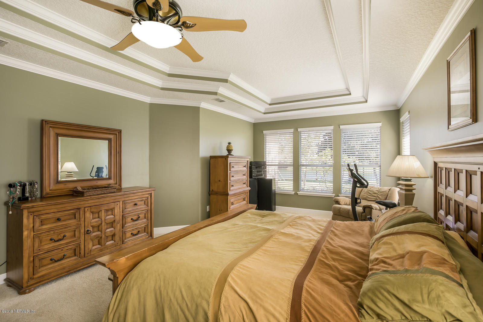 2034 River's Own Road St. Augustine, FL 32092 - Photo 25 of 40 a bedroom with a large bed and a chandelier