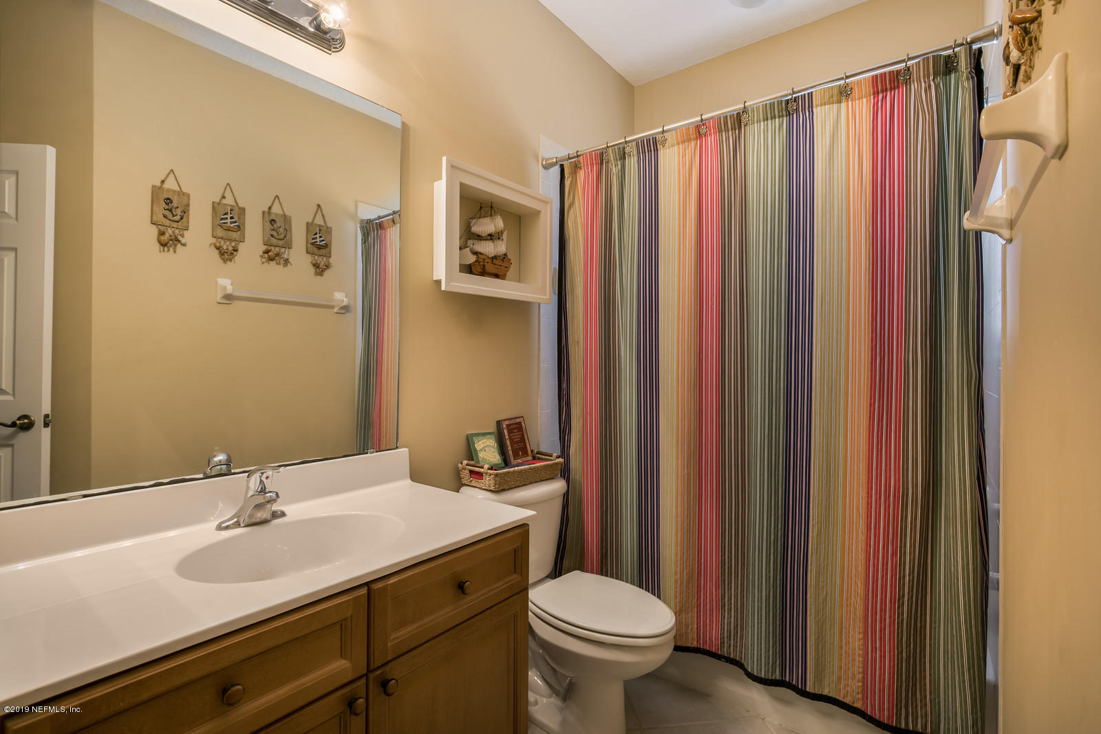 2034 River's Own Road St. Augustine, FL 32092 - Photo 29 of 40 a bathroom with a sink and a mirror