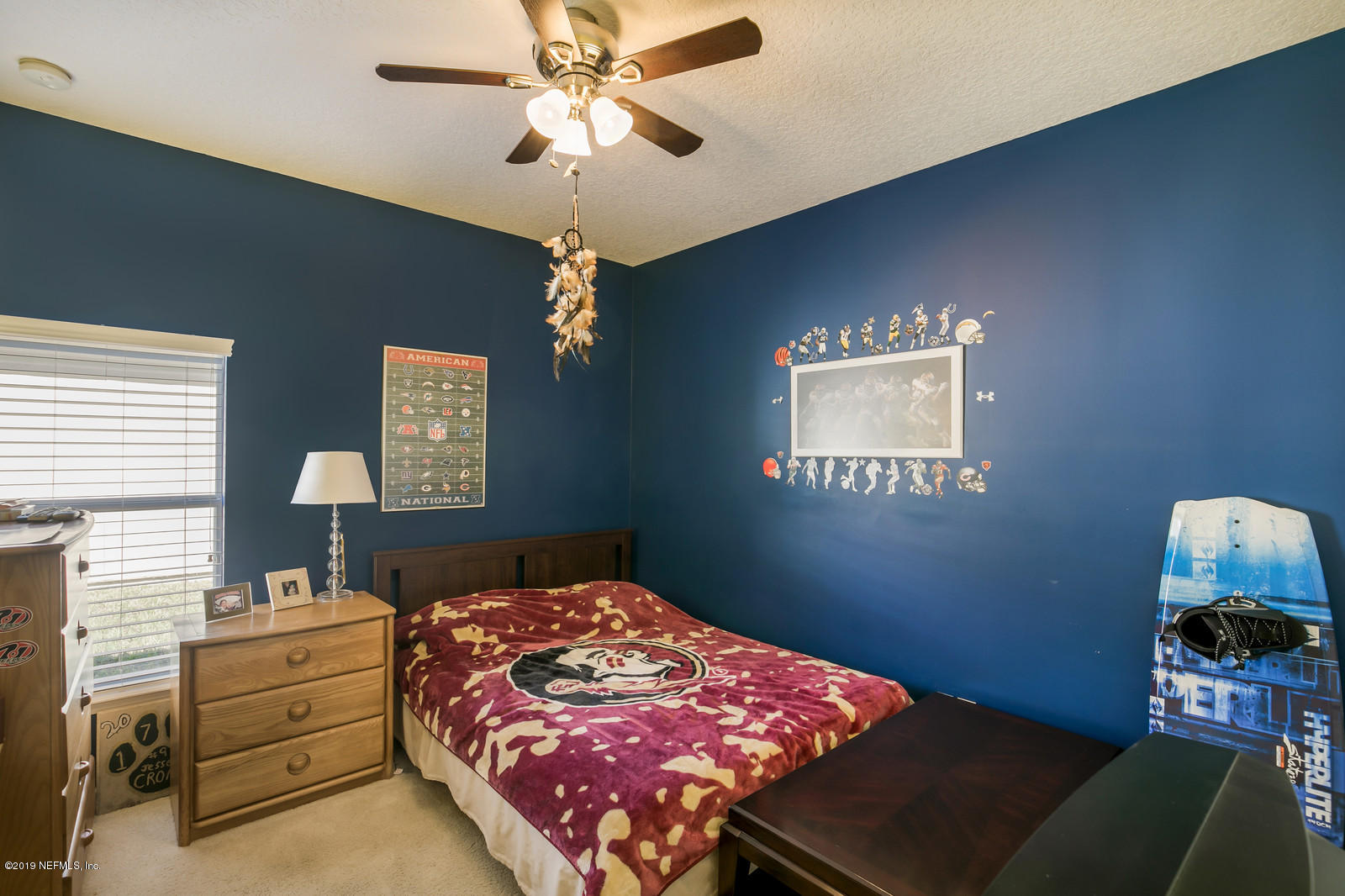 2034 River's Own Road St. Augustine, FL 32092 - Photo 30 of 40 a bedroom with a bed and a chandelier