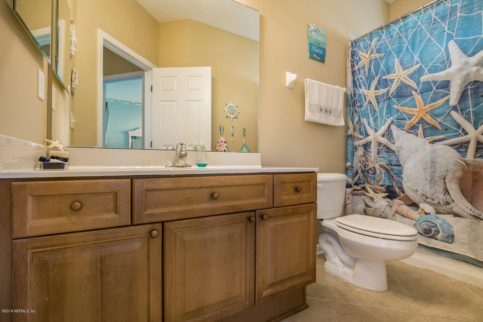 2034 River's Own Road St. Augustine, FL 32092 - Photo 32 of 40 a bathroom with a sink toilet and mirror