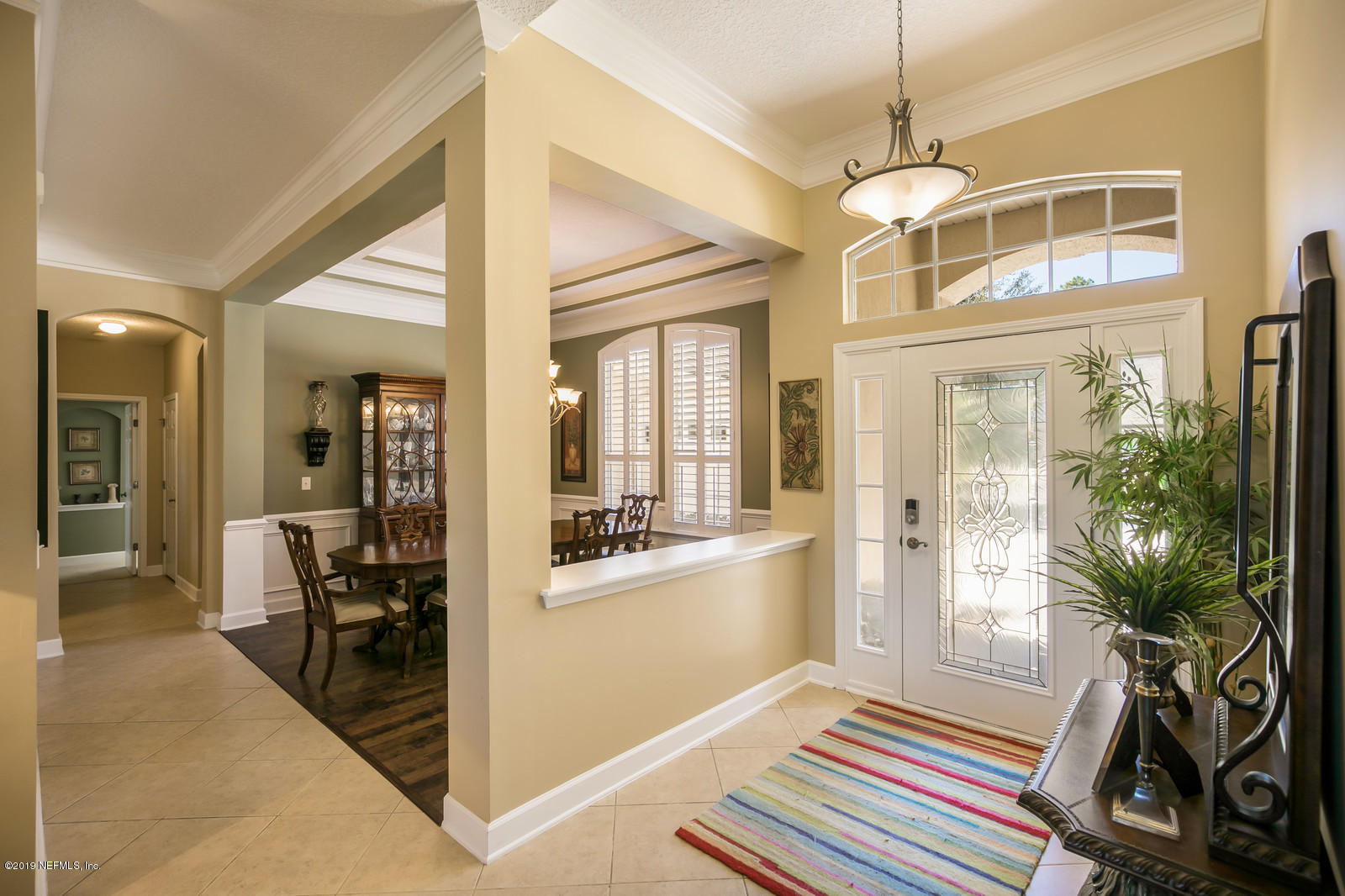 2034 River's Own Road St. Augustine, FL 32092 - Photo 5 of 40 a workspace with wooden floor and a chandelier
