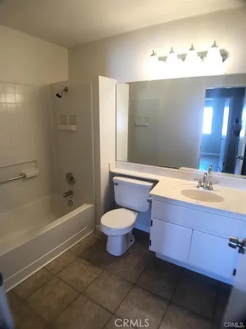 a bathroom with a toilet a sink and bathtub